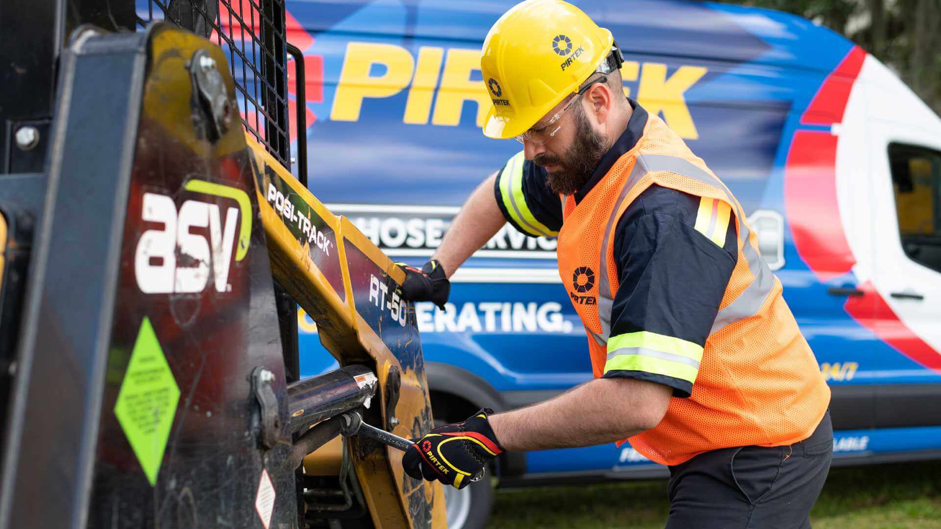 Picture a Technician Sitting at a Blue Counter in a PIRTEK Store, Serving Customers with Hydraulic Hose Repair Franchise.